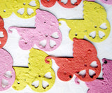 Recycled Ideas Favors plantable paper red, yellow and pink baby carriages