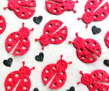 red seed paper ladybugs with black hearts