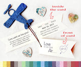 Recycled Ideas Favors plantable paper blue airplane with cards and map hearts